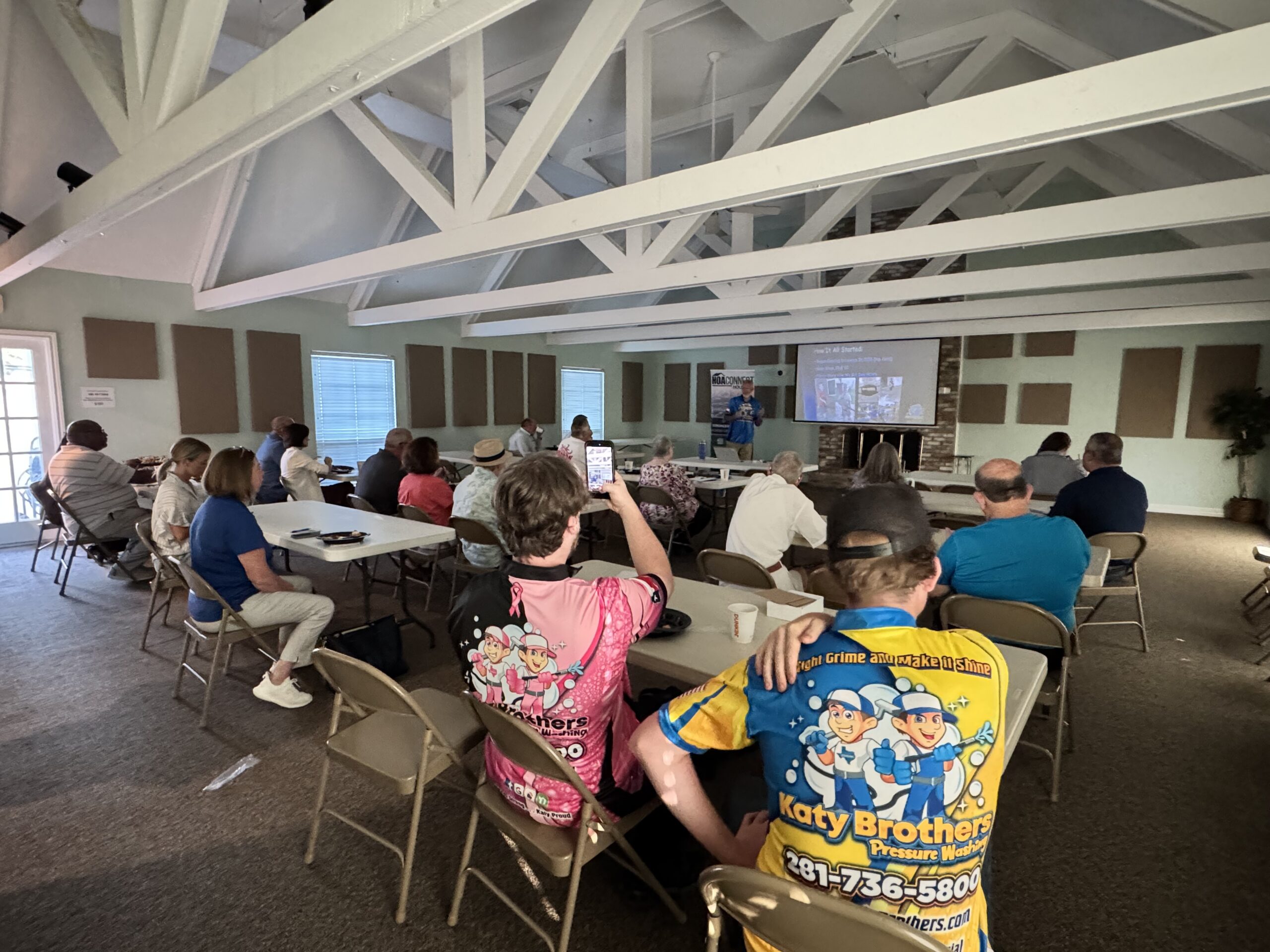 Attendees gathered around tables at an HOA Connect Houston workshop